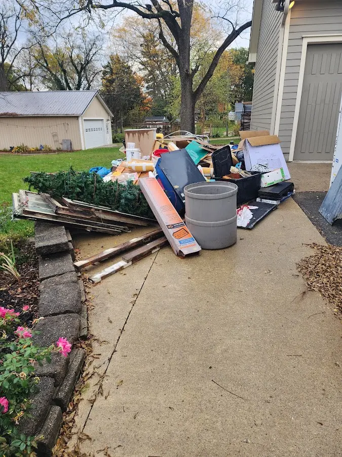 Dumpster being loaded with debris for 12 Yard Dumpster Rental in Barnesville
